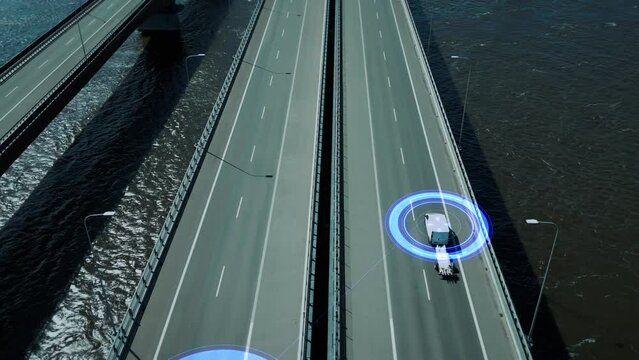 Driverless self-driving cars drive across the bridge and interact with other vehicles. Concept of autonomous transport, the smart roads of the future. Visualization with HUD elements. Aerial view. 4k