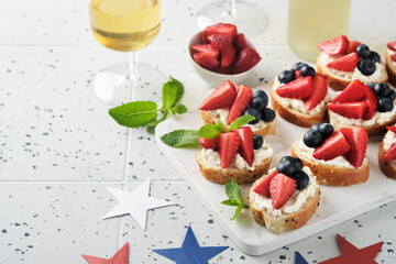 American flag sandwich with strawberries, blueberries, whipped sweet cream, soft cheese on toast bread. 4th of July American Independence Day food. Independence or Patriotic Day breakfast idea Mock up