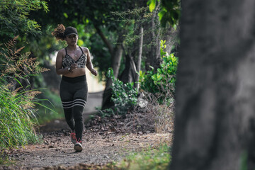 Latin woman running in a green field in the forest. Peru.
