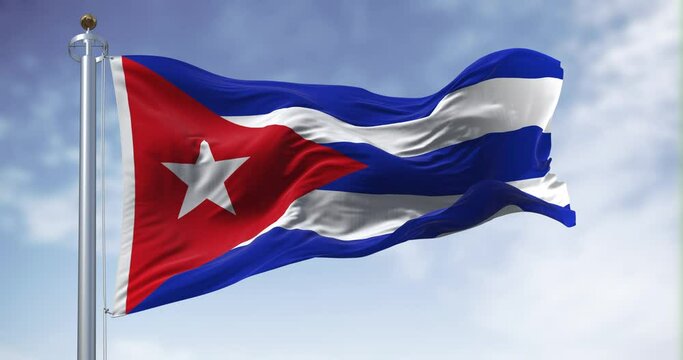 Seamless loop in slow motion of Cuba national flag waving on a clear day