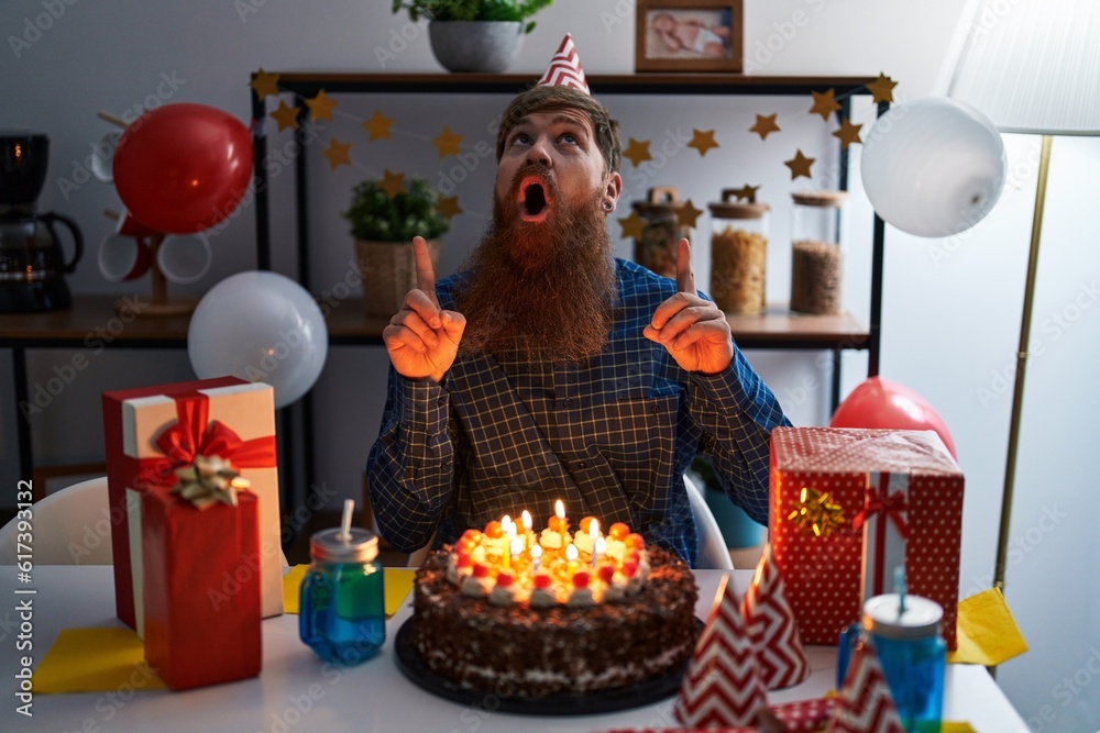 Canvas Prints caucasian man with long beard celebrating birthday holding big chocolate cake amazed and surprised l