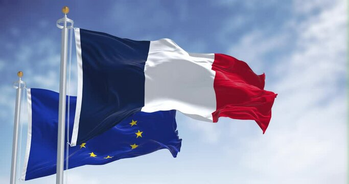 Seamless loop in slow motion of France and the EU flags waving on a clear day