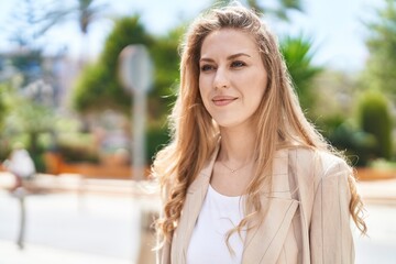 Fototapeta premium Young blonde woman smiling confident standing at park