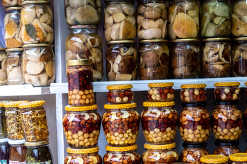 Close up glass jars display shelf delicious handmade eco dessert assorted nuts and honey. Shop of farm products in the Ukrainian Carpathians. locally grown food