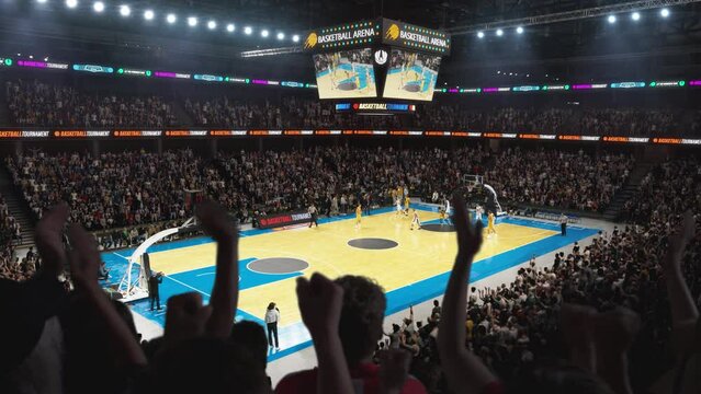 High Angle Establishing Wide Shot of a Whole Arena of Spectators Watching a Basketball Championship Game. Teams Play, Crowds of Fans Raise Hands and Cheer. Sports Channel Live Television Broadcast