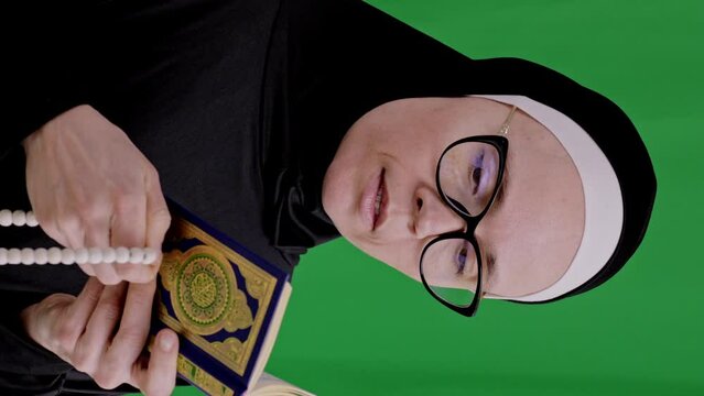 Modern muslim woman is counting praying beads