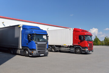 Fototapeta na wymiar Trucks loading at a depot of a forwarding agency - Transport and logistics in goods trade