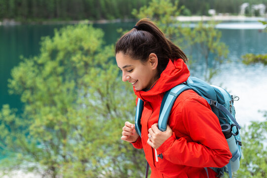 Close up portrait of a woman hiking enjoying the freshness of mountains air