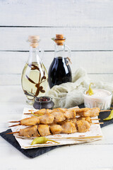 Chicken kebab with sour cream sauce. Chicken skewers on wooden background