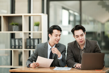 Group of business man discussion and brainstorming, bookkeeping audit graph and chart documents at desk, teamwork concept.