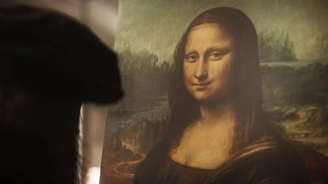 Close Up on The Painting of the Mona Lisa Being Created by Leonardo da Vinci in his Workshop. Renaissance Era Historical Figure and Painter Gently Adding Details to his Masterpiece on the Canvas