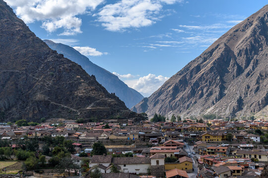 Ollantaytambo, a small town in the mountains, zig zag paths and terraces on the hillside and houses of the town.