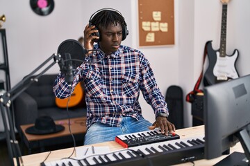 African american man musician having dj session at music studio