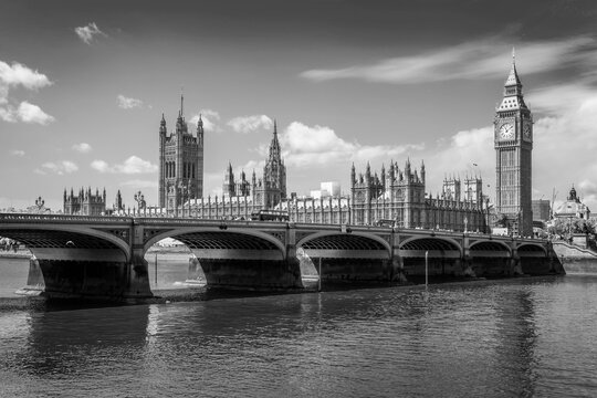 Westminster bridge over river Thames, Big Ben and the houses of parliament in London, UK. Black and white photography.