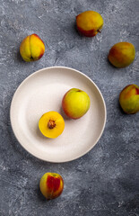 Freshly Picked Farm-Fresh Peach Fruits on a White Ceramic Plate