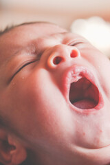 Newborn baby face yawning