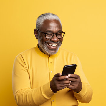 Black Senior Man Using A Phone On A Yellow Background. Generative AI.