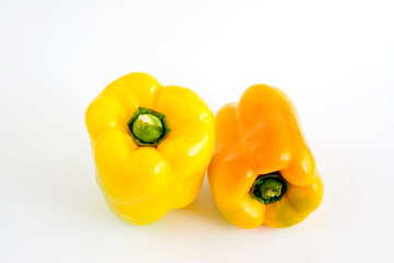 yellow and orange paprika isolated on white background, close up 