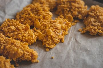 Slices of natural organic chicken cutlet coated in egg and cornflakes to create the perfect crispy...