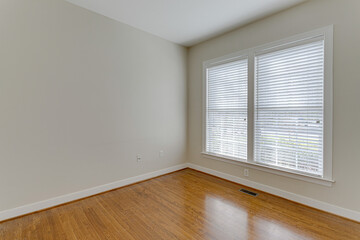 Light Empty Modern Bedroom Interior with Hardwood Floors and Grey Walls
