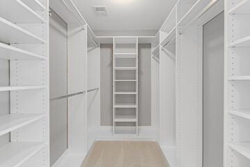 Luxury Empty Primary White Bedroom Closet With Tons Of Storage