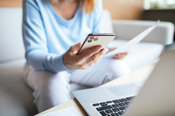 Mid adult woman going over bills at home