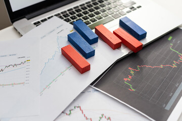 Alarm clock and a pile of golden coins on the table, Concept of opportunity cost time and Money saving. Arrange coins into heaps with hands, content about money.