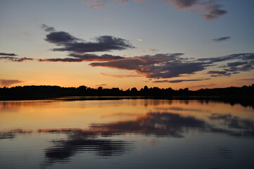 Obraz na płótnie Canvas Summer sunset over a lake