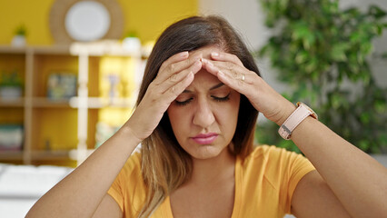 Middle eastern woman stressed sitting on sofa at home