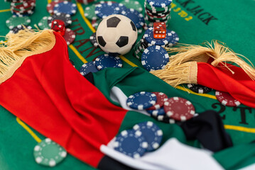  Casino gambling chips and playing cards on green table