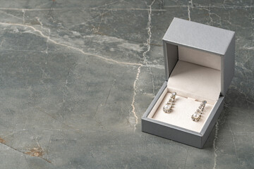 Jewelry box with earrings on a gray background