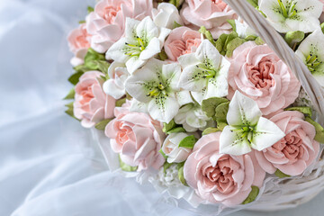 Zephyr bouquet of flowers in a gift box on a light background.