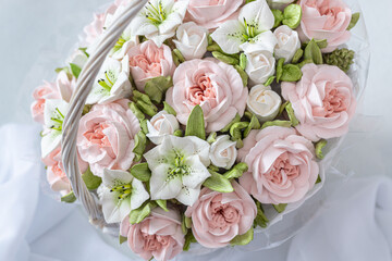Zephyr bouquet of flowers in a gift box on a light background.