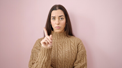 Young beautiful hispanic woman doing no gesture over isolated pink background