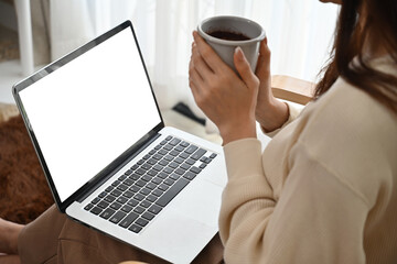 Close up with Empty screen of laptop on female's lap and Asian woman with long-sleeve held and...