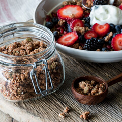 Healthy protein granola clusters with a nutrient dense breakfast bowl in behind