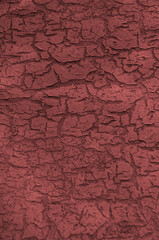cracked pink paint on wooden background.light red unusual texture. abstract corrugated pink surface