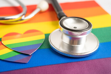 Black stethoscope on rainbow flag with heart, symbol of LGBT pride month celebrate annual in June...