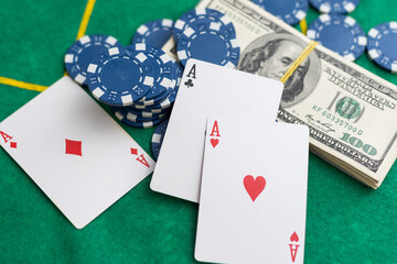 Poker playing chips with card and dollar banknoteson a casino green table. Online gambling. Texas