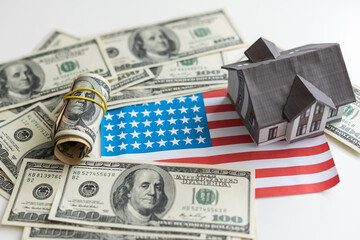 little house model with many dollar banknotes and keys. Real estate insurance. Investment