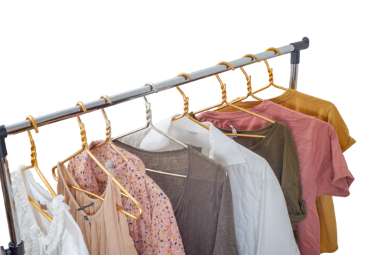 Second-hand clothes on the rail on a light background. The concept of sustainable economic life. 