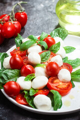 Obraz na płótnie Canvas Caprese salad with tomato, mozzarella and basil