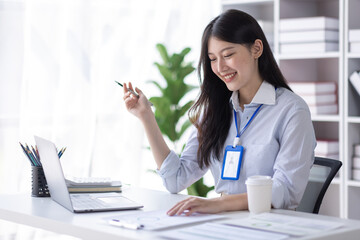 Business Asian woman work documents on laptop computer at office with calculator accounting on desk, do planning analyzing the financial report, business plan investment, finance analysis concept.