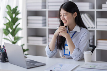 Obraz premium Business Asian woman work documents on laptop computer at office with calculator accounting on desk, do planning analyzing the financial report, business plan investment, finance analysis concept.