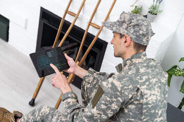 Telemedicine Concept. Military man Having Video Call With Therapist Using Digital Tablet, Getting...