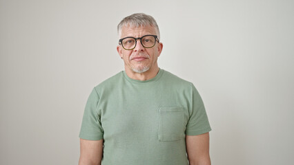 Middle age grey-haired man wearing glasses standing over isolated white background