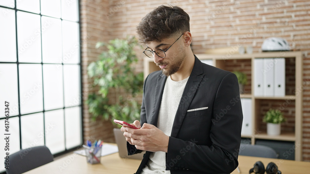 Sticker Young arab man business worker using smartphone at office