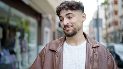 Young arab man smiling confident standing at street