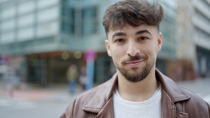 Young arab man smiling confident standing at street