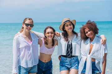 Happy children laughing and enjoying at beach. Teenage playing with friends at the sea. Vacations time and friendship concept.